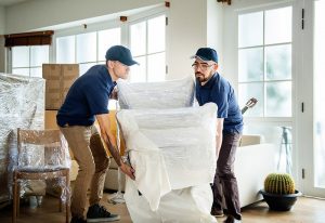 two guys carrying home furniture