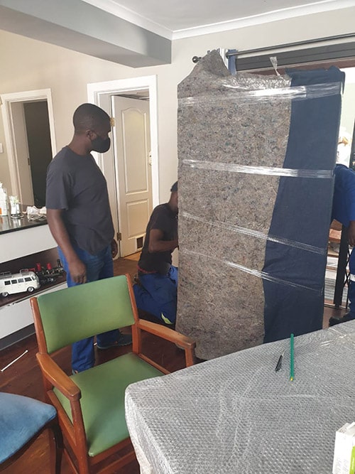 house-packaging Men packaging furniture for removal